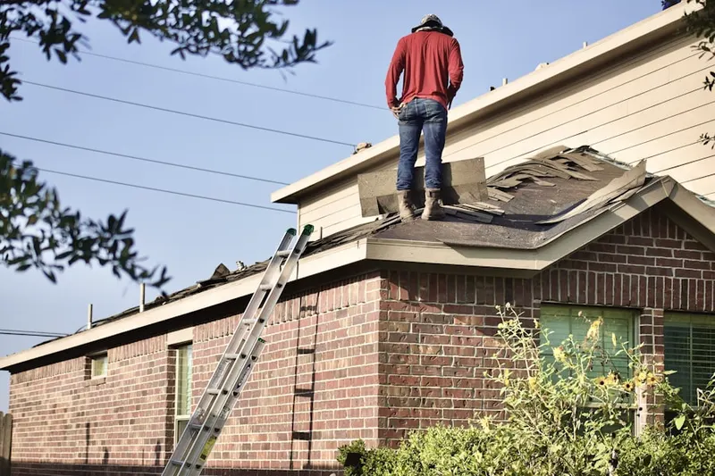 Professional roofer working on a residential roof in Pheasant Hill